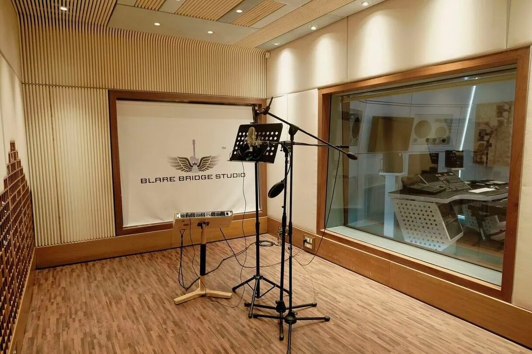 Recording room with microphone and isolation glass